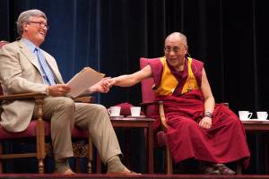 James Doty, left, director and founder of the Center for Compassion and Altruism Research and Education, and the Dalai Lama at the morning lecture at Maples Pavilion.